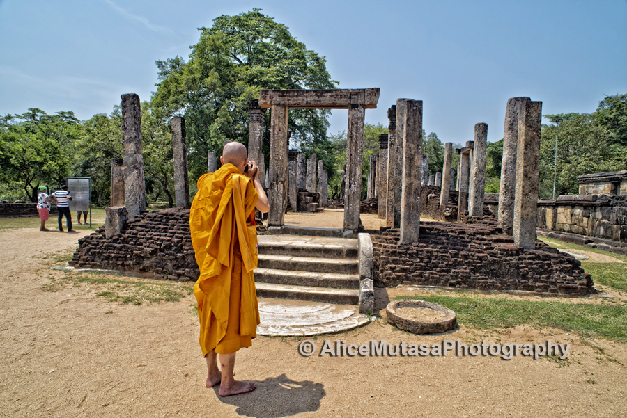 Monk taking a photo in Polonaruwa