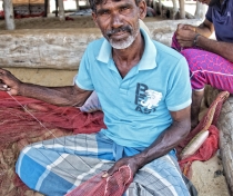 Kiriba - mending fishing nets near Dolphin Beach