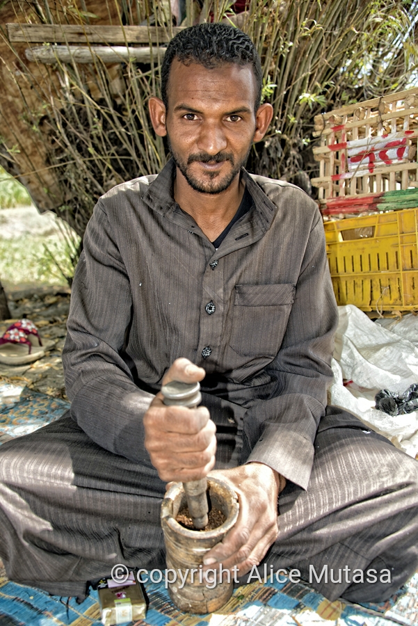 Hasem grinding coffee on the bank of the Nile near Aswan