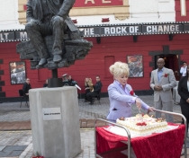 Barbara cutting the birthday cake for Joan Littlewood