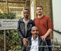 Tesfay (L) with his father Samuel (seated) and their solicitor Daniel Rourke