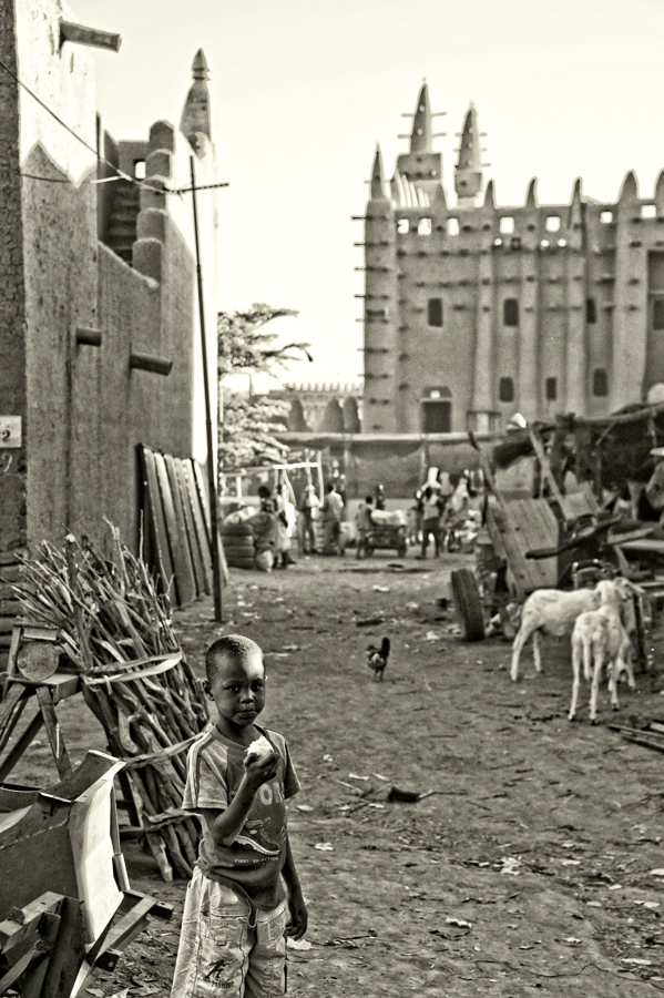 Small boy with Great Mosque of Djenné in the background