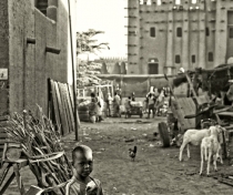 Small boy with Great Mosque of Djenné in the background