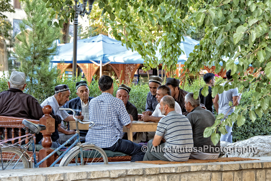 Local life; men playing a board game by the Labi Hauz pool, Bukhara